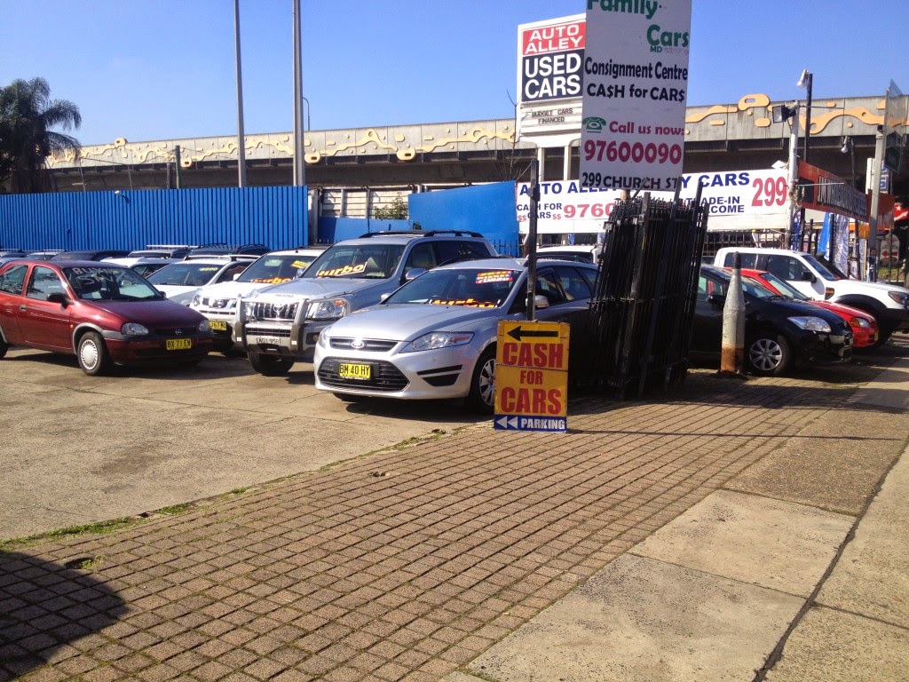 The pylon sign reading Consignment Centre, CA$H for CAR$, MDL 55140 and 299 Church St, above the front row of the yard